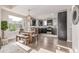Open kitchen and dining area with modern appliances and hardwood floors at 10305 Martin Luther King Blvd, Denver, CO 80238