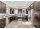 Modern kitchen equipped with stainless steel appliances, dark wood cabinets, and granite countertops at 10305 Martin Luther King Blvd, Denver, CO 80238