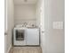Bright laundry room features a white washer and dryer and a white wire shelf at 10305 Martin Luther King Blvd, Denver, CO 80238