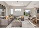 Spacious living room featuring a sectional sofa, accent pillows and hardwood floors at 10305 Martin Luther King Blvd, Denver, CO 80238