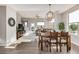 Bright, open-concept living space features hardwood floors and a dining area with a modern chandelier at 10305 Martin Luther King Blvd, Denver, CO 80238