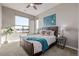 Cozy main bedroom with a large window offering city views, side tables, and stylish decor at 10305 Martin Luther King Blvd, Denver, CO 80238