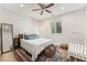 Charming bedroom showcasing a crib, warm rug, and ample natural light at 162 Starlight Cir, Erie, CO 80516