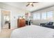 Bright bedroom featuring a large window, dresser, and cozy seating area for relaxation at 162 Starlight Cir, Erie, CO 80516