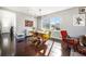 Open dining area with hardwood floors, stylish lighting, and ample natural light at 162 Starlight Cir, Erie, CO 80516
