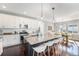 Stylish kitchen boasts a granite island with barstool seating and stainless steel appliances at 162 Starlight Cir, Erie, CO 80516