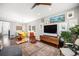 Open-concept living area featuring hardwood floors, TV, and ample natural light at 162 Starlight Cir, Erie, CO 80516