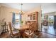 Inviting dining room with hardwood floors, chandelier, and a large wooden table at 7930 Larkspur Cir, Frederick, CO 80530