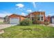 Landscaped front yard featuring a well-manicured lawn and tree at 7930 Larkspur Cir, Frederick, CO 80530