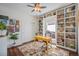 Bright home office featuring custom built-in bookshelves, a desk, and natural light at 7930 Larkspur Cir, Frederick, CO 80530
