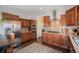 Stylish kitchen with stainless steel appliances, tiled backsplash, and wood cabinetry at 7930 Larkspur Cir, Frederick, CO 80530