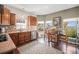 Charming kitchen with stainless steel appliances, wood cabinets, and an eat-in nook at 7930 Larkspur Cir, Frederick, CO 80530