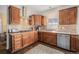 Modern kitchen with stainless steel appliances, mosaic backsplash, and wood cabinets at 7930 Larkspur Cir, Frederick, CO 80530