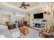 Cozy living room with a decorative ceiling, fireplace, and ample seating at 7930 Larkspur Cir, Frederick, CO 80530