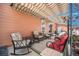 Cozy covered patio area with comfortable seating, perfect for outdoor relaxation and entertainment at 7930 Larkspur Cir, Frederick, CO 80530