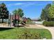 Community playground featuring slides, climbing structure and soft landing with benches at 7930 Larkspur Cir, Frederick, CO 80530