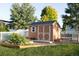 Exterior shot of a backyard shed featuring a raised garden bed with a white fence and a bench at 7930 Larkspur Cir, Frederick, CO 80530