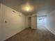 Basement features carpet flooring, light walls, and natural light peering from a window at 16485 E 17Th Pl # D, Aurora, CO 80011