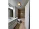 Well-lit bathroom boasts a vanity sink, neutral tile, and a shower-tub combination for convenience at 16485 E 17Th Pl # D, Aurora, CO 80011