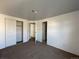 Carpeted bedroom displaying double door closet, closet with no door, and an open doorway at 16485 E 17Th Pl # D, Aurora, CO 80011