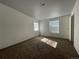Bright bedroom offering carpeted floors, multiple windows, and ample space for a comfortable retreat at 16485 E 17Th Pl # D, Aurora, CO 80011