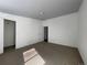 Bedroom showing neutral walls, carpet flooring, with access to closet and additional doors at 16485 E 17Th Pl # D, Aurora, CO 80011