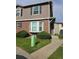 Charming townhome with a brick facade, bay window, and well-manicured landscaping in a residential neighborhood at 16485 E 17Th Pl # D, Aurora, CO 80011