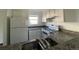 Kitchen showcases granite countertops, white appliances, and natural light for a bright, airy space at 16485 E 17Th Pl # D, Aurora, CO 80011