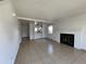 Spacious living room featuring tile floors, fireplace, and open access to the kitchen for easy entertaining at 16485 E 17Th Pl # D, Aurora, CO 80011