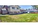 Large backyard with green grass, privacy fence, and patio area at 8561 E Grand Ave, Denver, CO 80237