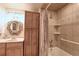 Bathroom featuring a built-in tub and shower, neutral tile work, vanity, and oval mirror at 8561 E Grand Ave, Denver, CO 80237