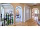 Hallway with arched doorways and hardwood floors at 8561 E Grand Ave, Denver, CO 80237