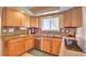 Kitchen with granite counters, stainless dishwasher and tile backsplash at 8561 E Grand Ave, Denver, CO 80237