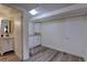 Spacious room with modern flooring, a white cabinet, and a door at 8561 E Grand Ave, Denver, CO 80237