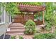 Inviting outdoor space featuring a wooden pergola, multi-level deck, and beautiful landscaping at 1449 Braewood Ave, Highlands Ranch, CO 80129