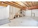 Unfinished basement offers potential for customization, featuring exposed beams, new mechanical, and concrete flooring at 1449 Braewood Ave, Highlands Ranch, CO 80129
