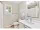 Bright bathroom with a large mirror, white vanity, and essential fixtures, offering a clean and functional space at 1449 Braewood Ave, Highlands Ranch, CO 80129