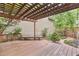Inviting deck with a wooden pergola, manicured garden, and brick walkway, perfect for outdoor relaxation and entertainment at 1449 Braewood Ave, Highlands Ranch, CO 80129