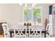 Bright dining area with a large window, hardwood floors, and comfortable seating at 1449 Braewood Ave, Highlands Ranch, CO 80129
