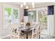 Bright dining room features a modern chandelier, deck access, and elegant decor for stylish and comfortable dining at 1449 Braewood Ave, Highlands Ranch, CO 80129