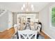 Comfortable dining area adjacent to the kitchen, featuring hardwood floors and a stylish chandelier at 1449 Braewood Ave, Highlands Ranch, CO 80129