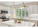 Well-lit kitchen featuring stainless steel appliances, an island with seating, and ample storage at 1449 Braewood Ave, Highlands Ranch, CO 80129