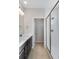Bathroom featuring a double vanity, glass-enclosed shower and a separate toilet room at 16798 W 94Th Way, Arvada, CO 80007