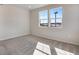 Bedroom with plush carpeting, two large windows, and abundant natural light at 16798 W 94Th Way, Arvada, CO 80007