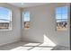 Bright bedroom with three windows offering views of the outside, plush carpet at 16798 W 94Th Way, Arvada, CO 80007