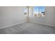 Neutral carpet in a bedroom with two large windows and great natural light at 16798 W 94Th Way, Arvada, CO 80007
