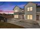 Charming townhome featuring a modern two-tone exterior and well-manicured landscaping at 16798 W 94Th Way, Arvada, CO 80007