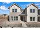 Inviting townhome with a modern facade, large windows, and a well-maintained walkway at 16798 W 94Th Way, Arvada, CO 80007