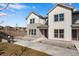 Charming townhome featuring a modern two-tone exterior and well-manicured landscaping at 16798 W 94Th Way, Arvada, CO 80007