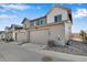 Townhome exteriors featuring garages, modern design, and well-maintained landscaping at 16798 W 94Th Way, Arvada, CO 80007